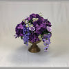 Purple floral centrepiece for wedding reception