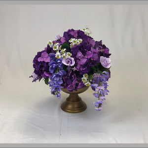 Purple floral centrepiece for wedding reception